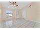 Bright living room featuring tile floors, a ceiling fan, and natural light from a window at 2665 Windsor Heights St, Deltona, FL 32738