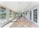Bright sunroom with tile flooring and multiple windows, perfect for enjoying natural light and outdoor views at 2665 Windsor Heights St, Deltona, FL 32738
