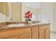 Well-lit bathroom with double vanity, tile flooring, and large mirror at 3050 Pirates Retreat Ct # 402, Kissimmee, FL 34747