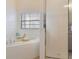 Bathroom featuring a soaking tub, glass shower and tile surround at 3050 Pirates Retreat Ct # 402, Kissimmee, FL 34747