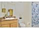 Clean bathroom featuring a vanity, decorative mirror and a toilet at 3050 Pirates Retreat Ct # 402, Kissimmee, FL 34747