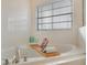 Relaxing white bathtub with tile surround, caddy and silver fixtures at 3050 Pirates Retreat Ct # 402, Kissimmee, FL 34747