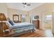 Bright bedroom with wood floors, a ceiling fan, and an ensuite bathroom at 3050 Pirates Retreat Ct # 402, Kissimmee, FL 34747