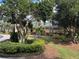 Well-maintained building exterior with lush landscaping and mature trees, creating a serene environment at 3050 Pirates Retreat Ct # 402, Kissimmee, FL 34747