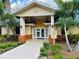 Clubhouse features an attractive entrance with manicured landscaping and signage at 3050 Pirates Retreat Ct # 402, Kissimmee, FL 34747