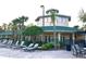Community clubhouse with palm trees, lounge chairs and a spacious courtyard at 3050 Pirates Retreat Ct # 402, Kissimmee, FL 34747