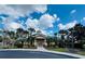 Community clubhouse features a green roof, ample parking and mature landscaping at 3050 Pirates Retreat Ct # 402, Kissimmee, FL 34747