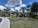 Community clubhouse with tropical landscaping and alligator lawn ornament at 3050 Pirates Retreat Ct # 402, Kissimmee, FL 34747