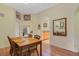 An open-concept dining room with wood-like floors, a table set for four, and a view into the kitchen at 3050 Pirates Retreat Ct # 402, Kissimmee, FL 34747