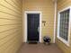 Exterior entrance door featuring a black door, unit number, and decorative window at 3050 Pirates Retreat Ct # 402, Kissimmee, FL 34747