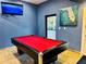 Game room features a black pool table with red felt and a Florida-themed painting at 3050 Pirates Retreat Ct # 402, Kissimmee, FL 34747