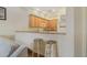 Cozy kitchen with light wood cabinets, breakfast bar, and stools, seamlessly connected to the living area at 3050 Pirates Retreat Ct # 402, Kissimmee, FL 34747
