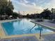 Beautiful outdoor pool with ample seating and tables, perfect for relaxation and socializing at 3050 Pirates Retreat Ct # 402, Kissimmee, FL 34747