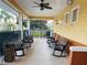 Inviting covered porch featuring rocking chairs and ceiling fans, perfect for relaxing outdoors at 3050 Pirates Retreat Ct # 402, Kissimmee, FL 34747