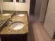 Bathroom featuring a double sink vanity with granite countertop and tile floor at 3561 Conroy Rd # 214, Orlando, FL 32839