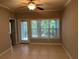 Bright living room featuring tile flooring, ceiling fan, and sliding glass doors to outdoor space at 3561 Conroy Rd # 214, Orlando, FL 32839