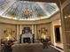 Exquisite lobby with painted ceiling, fireplace, chandelier, and comfortable seating at 3561 Conroy Rd # 214, Orlando, FL 32839