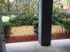 View of landscaped backyard from patio with beautiful plants and mulch at 3561 Conroy Rd # 214, Orlando, FL 32839