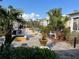 A relaxing pool area with lush greenery and multiple seating areas on a paved deck at 3561 Conroy Rd # 214, Orlando, FL 32839