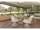 A sunroom with wicker seating, plants, and a view of the backyard at 400 Ruth St, Longwood, FL 32779