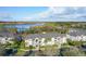 Aerial view of a condo complex near a lake, highlighting well-maintained grounds, ample parking, and scenic surroundings at 4280 Summer Landing Dr # 204, Lakeland, FL 33810