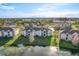A scenic aerial view shows several three-story condo buildings with a lake, and well-manicured lawns at 4280 Summer Landing Dr # 204, Lakeland, FL 33810