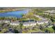 Aerial view showcasing the community with a scenic lake, well-maintained buildings, and ample parking spaces at 4280 Summer Landing Dr # 204, Lakeland, FL 33810