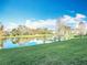 Backyard view of a tranquil lake surrounded by lush greenery, enhancing the property's natural beauty and appeal at 4280 Summer Landing Dr # 204, Lakeland, FL 33810