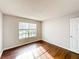 Bright bedroom with laminate wood floors and view to the front yard at 4280 Summer Landing Dr # 204, Lakeland, FL 33810