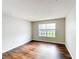 Bright bedroom with laminate wood floors and a large window to the yard at 4280 Summer Landing Dr # 204, Lakeland, FL 33810
