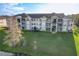 Well-kept, light-colored three-story condo building with balconies and a meticulously maintained green lawn at 4280 Summer Landing Dr # 204, Lakeland, FL 33810