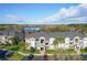 A beautiful, spacious, light-colored condo building with three stories is near a lake and has well-manicured lawns at 4280 Summer Landing Dr # 204, Lakeland, FL 33810