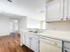 Bright kitchen featuring white cabinets, appliances, and views to living room at 4280 Summer Landing Dr # 204, Lakeland, FL 33810