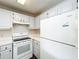 Bright kitchen featuring white cabinets and appliances and wood floors at 4280 Summer Landing Dr # 204, Lakeland, FL 33810