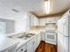 Bright kitchen featuring white cabinets and appliances at 4280 Summer Landing Dr # 204, Lakeland, FL 33810