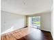 Empty living room with wood floors and sliding glass doors to balcony at 4280 Summer Landing Dr # 204, Lakeland, FL 33810