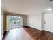 Empty living room with wood floors and sliding glass doors to balcony at 4280 Summer Landing Dr # 204, Lakeland, FL 33810