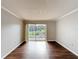 Empty living room with wood floors and sliding glass doors to balcony at 4280 Summer Landing Dr # 204, Lakeland, FL 33810