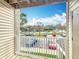 Balcony view overlooking a parking lot and landscaped greenery, offering a peaceful and scenic outdoor space at 4280 Summer Landing Dr # 204, Lakeland, FL 33810