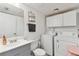 Bathroom with a sink, toilet, and stacked laundry machines at 4353 Shadow Crest Pl # 3, Orlando, FL 32811