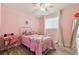A cheery pink bedroom with a bright window, chair, and a large full-length mirror at 4353 Shadow Crest Pl # 3, Orlando, FL 32811