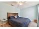 This is a cozy bedroom with a wood-framed bed and light gray wood-look floors at 4353 Shadow Crest Pl # 3, Orlando, FL 32811
