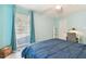 Bedroom with bright blue walls, ceiling fan, and a sunny window with curtains at 4353 Shadow Crest Pl # 3, Orlando, FL 32811