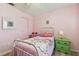 Bedroom with pink walls, chair, and a green nightstand with matching drawers at 4353 Shadow Crest Pl # 3, Orlando, FL 32811