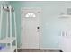 Bright entryway with coat rack and a white painted front door at 4353 Shadow Crest Pl # 3, Orlando, FL 32811