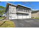 Exterior view of townhome featuring a screened balcony over a three-car garage and a paved driveway at 4353 Shadow Crest Pl # 3, Orlando, FL 32811