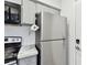 Close up of kitchen featuring a stainless steel refrigerator and a built-in microwave oven at 4353 Shadow Crest Pl # 3, Orlando, FL 32811