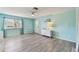 Bright, modern living room with vinyl floors and large front window at 4353 Shadow Crest Pl # 3, Orlando, FL 32811