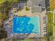 Overhead view of a large, rectangular swimming pool, surrounded by a paved deck with lounge chairs and manicured landscaping at 4353 Shadow Crest Pl # 3, Orlando, FL 32811
