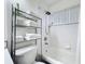 Bathroom featuring a tub/shower combo, toilet, and metal shelving at 458 Hollinghead Loop, Davenport, FL 33896
